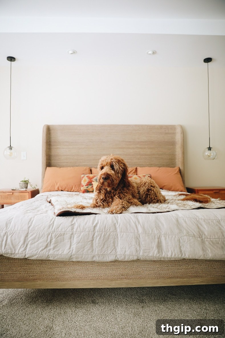 Eco-Friendly Bedding Brands 2 A beautifully made bed with crisp, white sustainable bedding and a throw blanket, inviting peaceful rest.