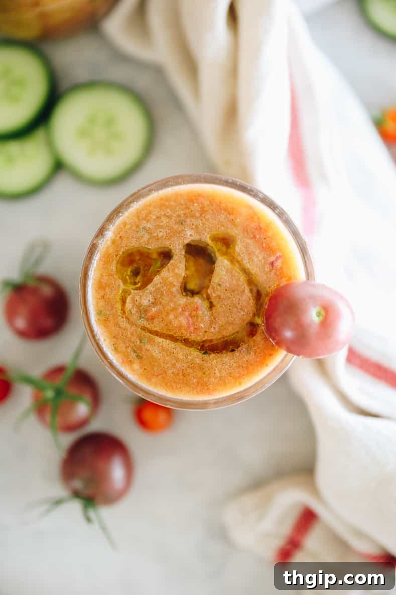 Simple Summer Gazpacho 9 A bowl of fresh gazpacho soup with various toppings like herbs and croutons.