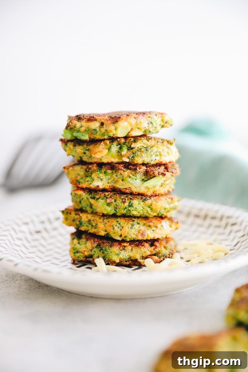 Crispy Broccoli Cheddar Bites 2 Freshly made golden brown broccoli cheddar fritters on a wooden board with a light background.
