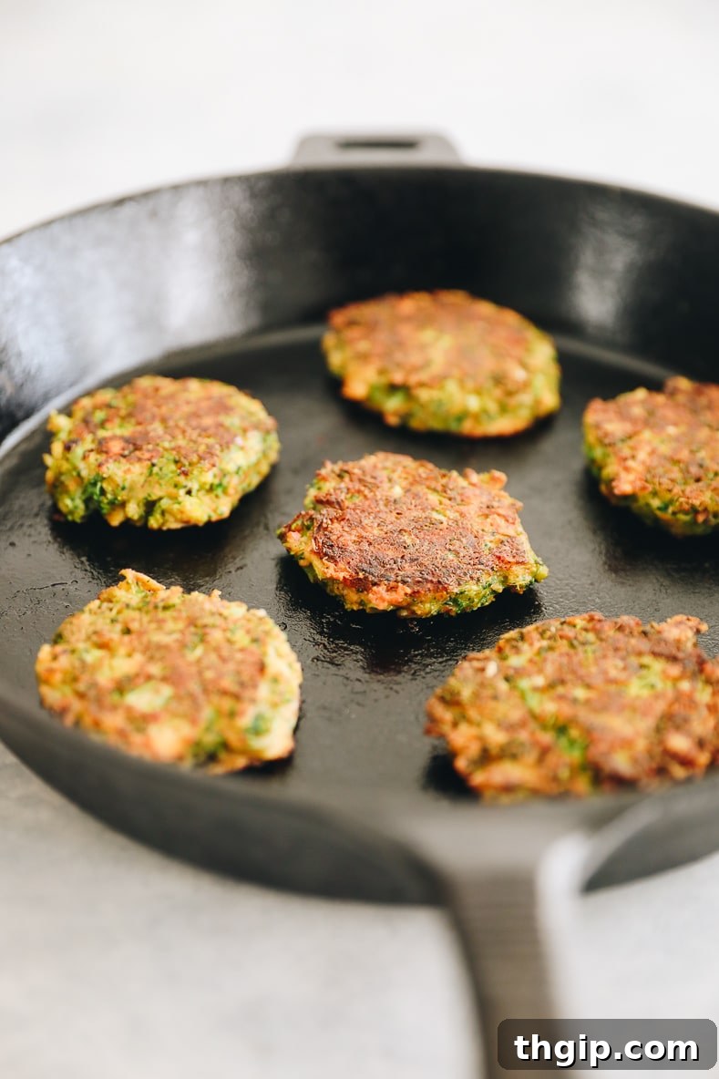 Crispy Broccoli Cheddar Bites 6 Broccoli cheddar fritters sizzling in a hot pan, turning golden brown.