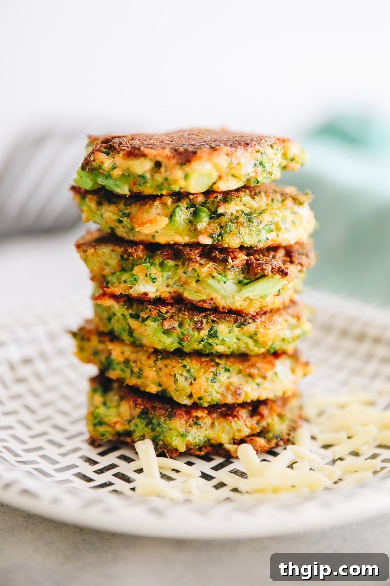 Crispy Broccoli Cheddar Bites 8 A stack of golden brown broccoli cheddar fritters, garnished with fresh herbs.
