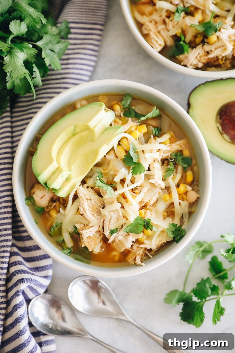 Creamy Instant Pot White Chicken Chili 2 A bowl of creamy Instant Pot White Chicken Chili garnished with fresh cilantro and a lime wedge.