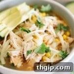 A featured image of a bowl of Instant Pot White Chicken Chili with garnishes.