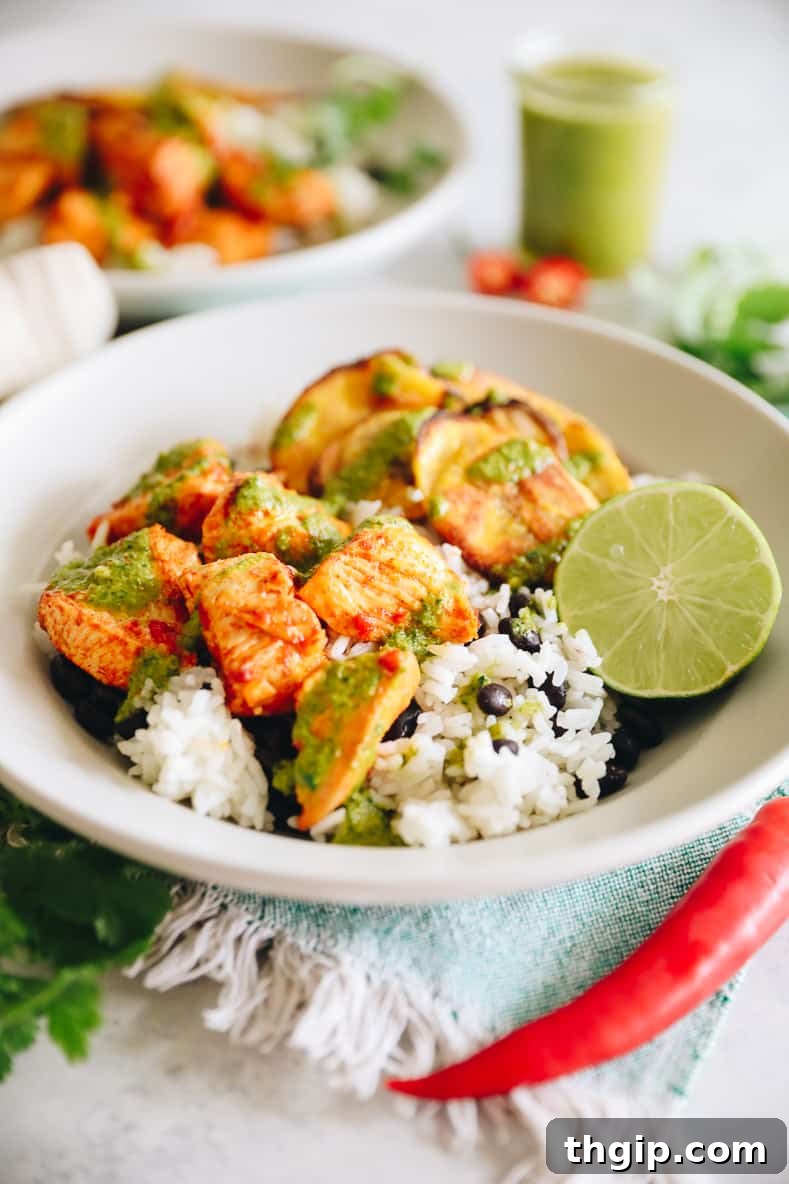 A vibrant Piri Piri Chicken Bowl with spicy chicken, rice, beans, and roasted plantains.