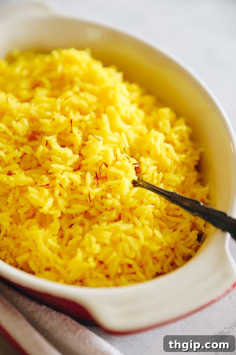 Fragrant Golden Saffron Rice 2 Vibrant yellow saffron rice served in an elegant baking dish, ready to enjoy.