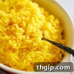 Close up shot of saffron rice in a serving dish.