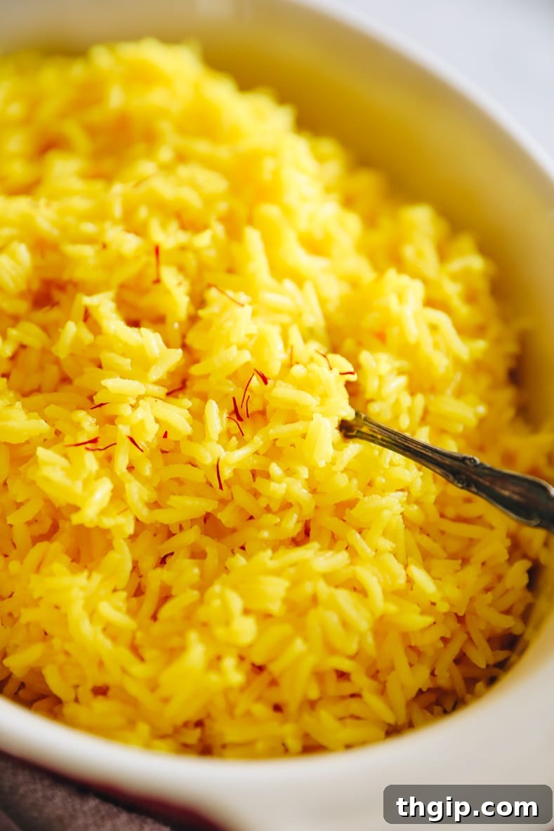 Fragrant Golden Saffron Rice 7 Up-close view of saffron rice in a baking dish, garnished with saffron threads for a vibrant finish.