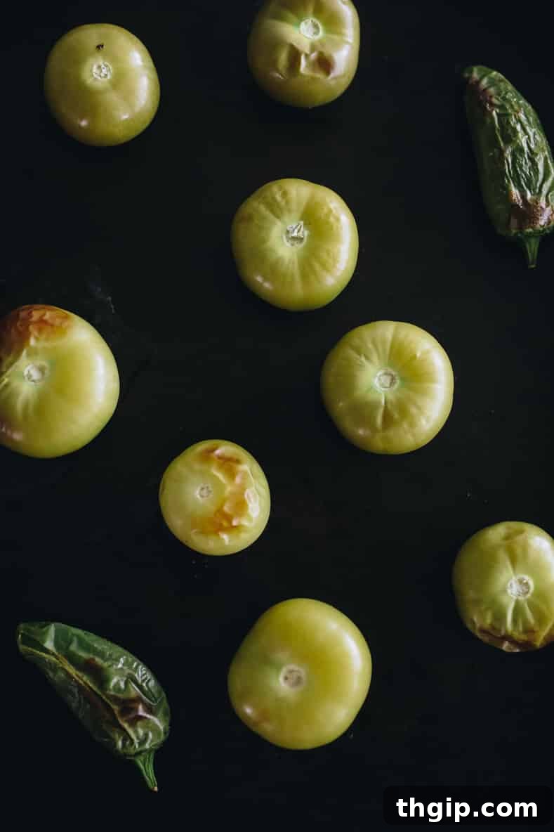 Fresh and Easy Salsa Verde 4 Roasted tomatillos and jalapeños on a baking sheet, ready for blending.
