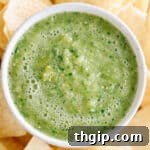 Close up shot of small dish of green salsa.