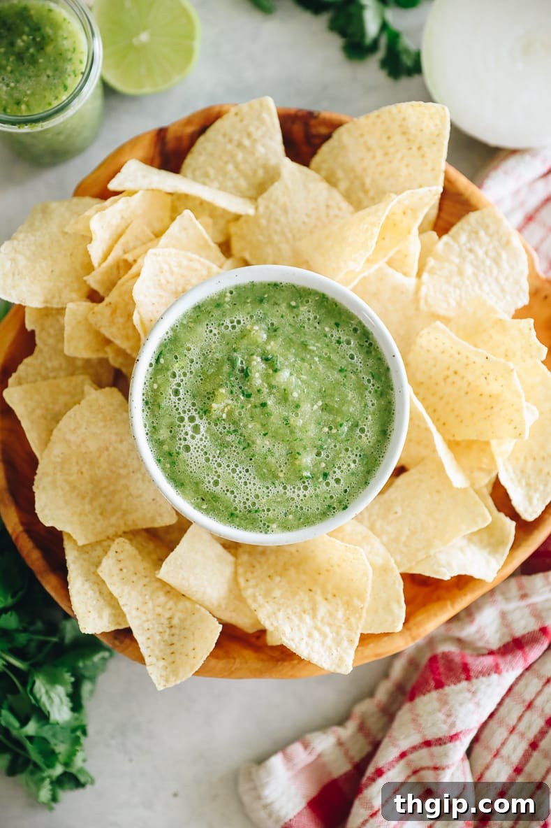 Fresh and Easy Salsa Verde 8 A serving of green salsa with roasted tomatillos and fresh cilantro in the background.
