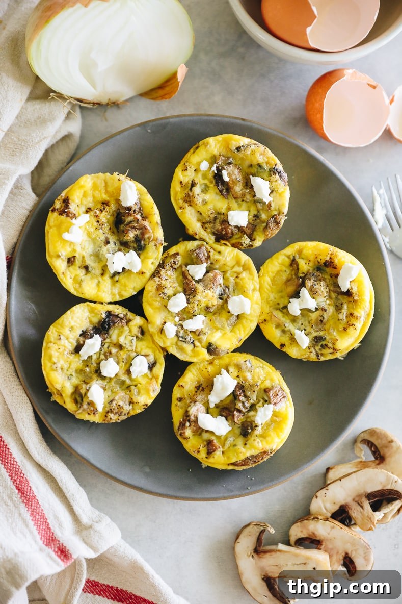 A close-up of a single mushroom and goat cheese egg muffin, showing its fluffy texture and ingredients.