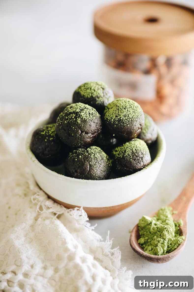 Matcha Chocolate Power Bites 2 Close-up shot of a plate of vibrant green Chocolate Matcha Energy Balls, dusted with extra matcha powder, ready to be enjoyed.