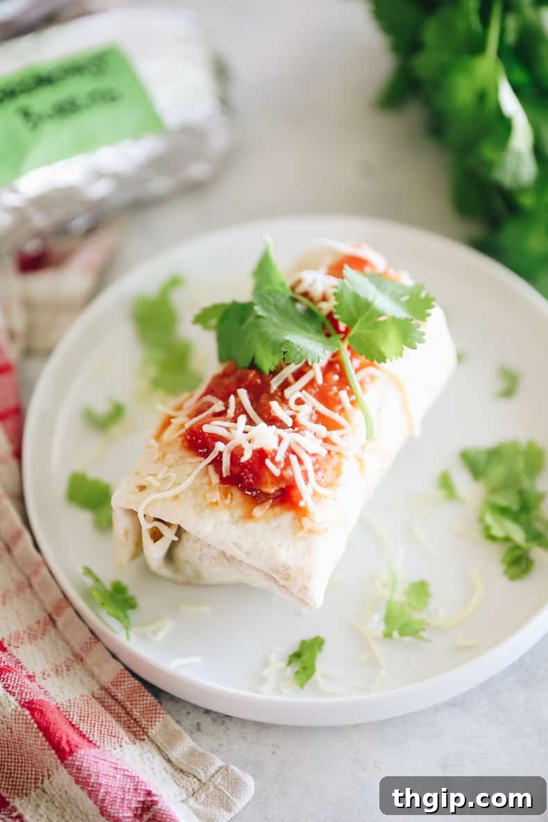 Grab-and-Go Frozen Breakfast Burritos 11 Reheated freezer breakfast burritos served with fresh salsa, shredded cheese, and cilantro, ready to eat.