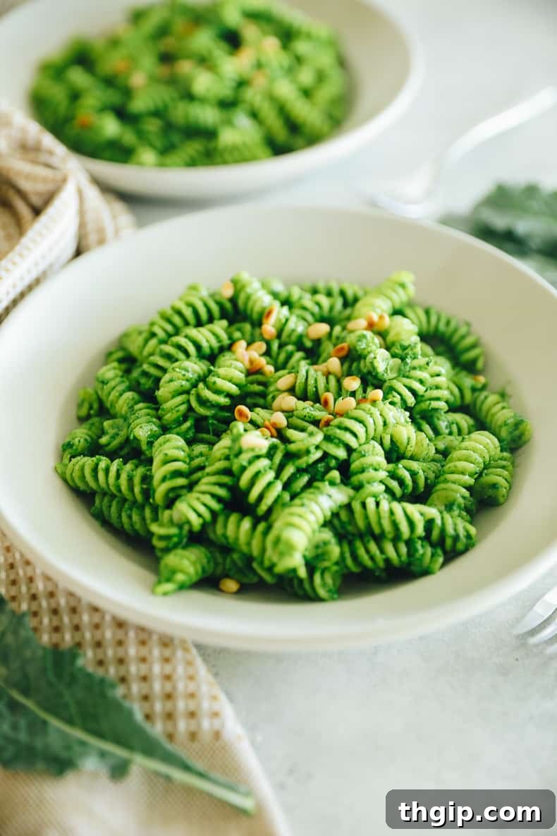Verdant Kale Pesto Pasta 2 A vibrant bowl of kale pesto pasta garnished with fresh herbs and cheese.