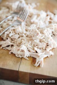 shredded chicken on a cutting board