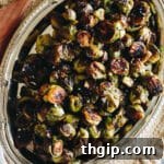 Delicious roasted Brussels sprouts with balsamic glaze on a silver platter, ready to be served.