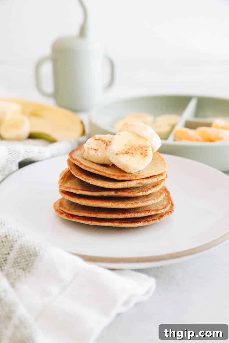Stacked baby banana pancakes, golden brown and fluffy, ready to be served to babies and toddlers.