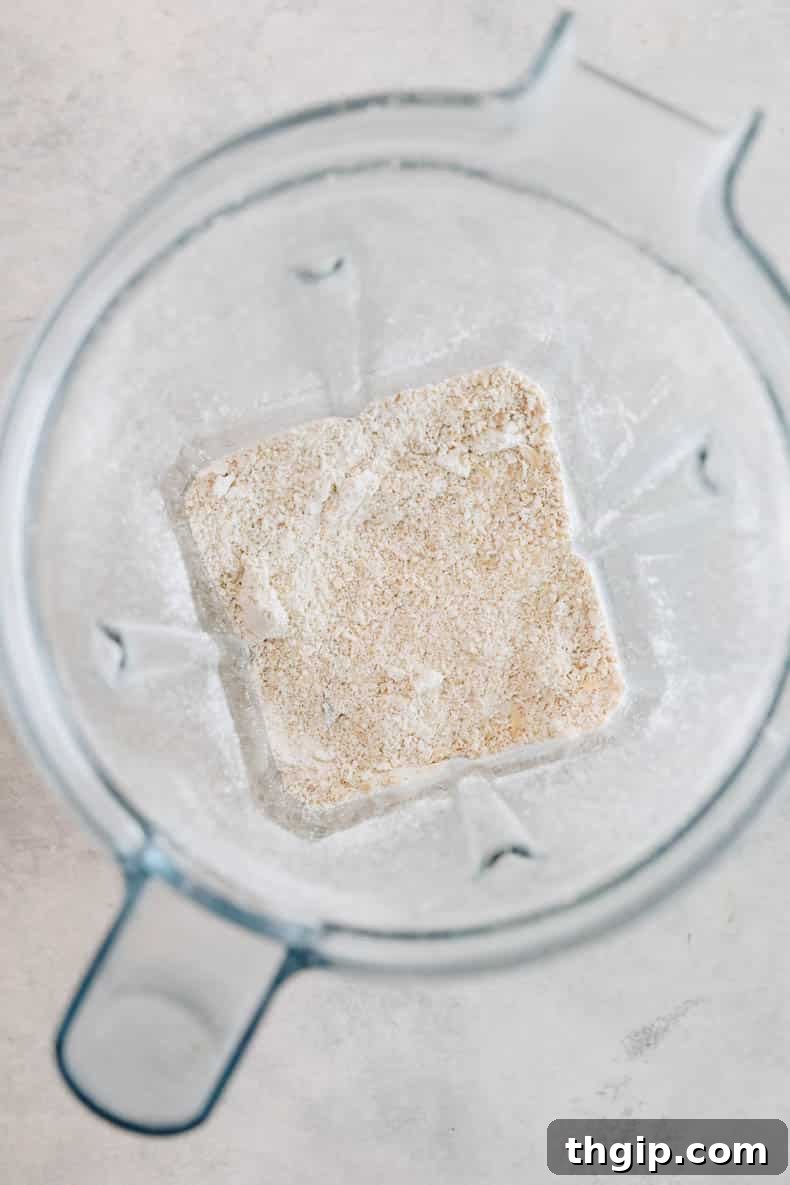 Ground up rolled oats forming a fine oat flour in a blender, ready for pancake batter.