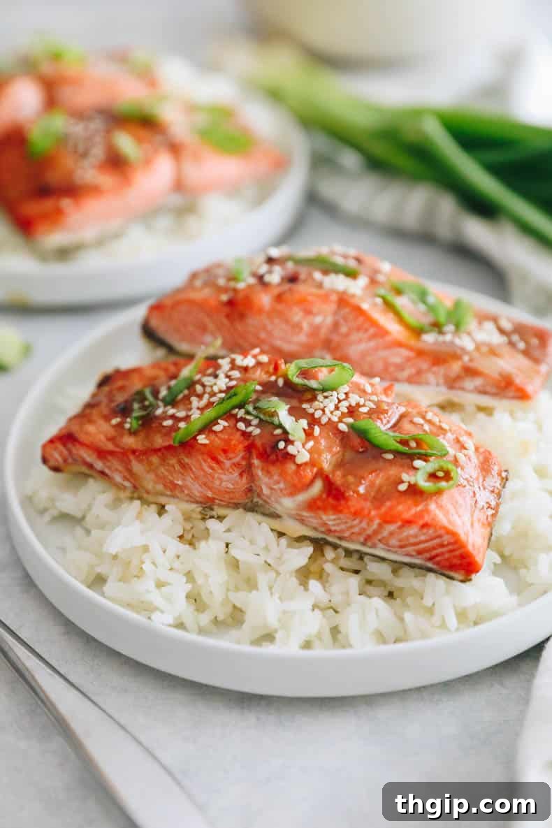 Effortless Miso Glazed Salmon 2 Miso salmon recipe with sesame seeds and green onions on a bed of rice.