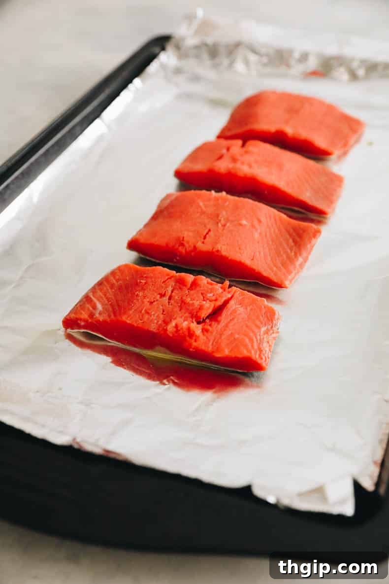 Effortless Miso Glazed Salmon 3 fresh salmon on a baking sheet lined with tinfoil