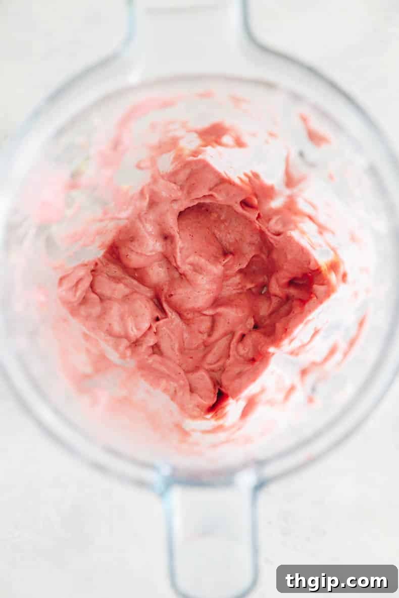 Vibrant Bowl Blends 4 A blender filled with purple smoothie ingredients, ready to be blended into a creamy smoothie bowl.