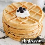 stack of protein waffles topped with greek yogurt and blueberries.