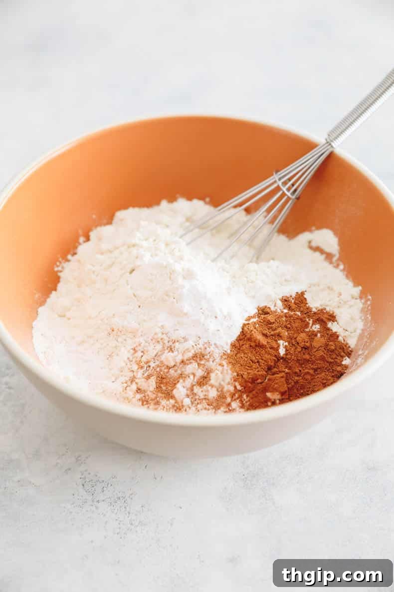 Golden Yam Griddlecakes 4 flour, cinnamon, baking powder and nutmeg in a mixing bowl with a whisk.