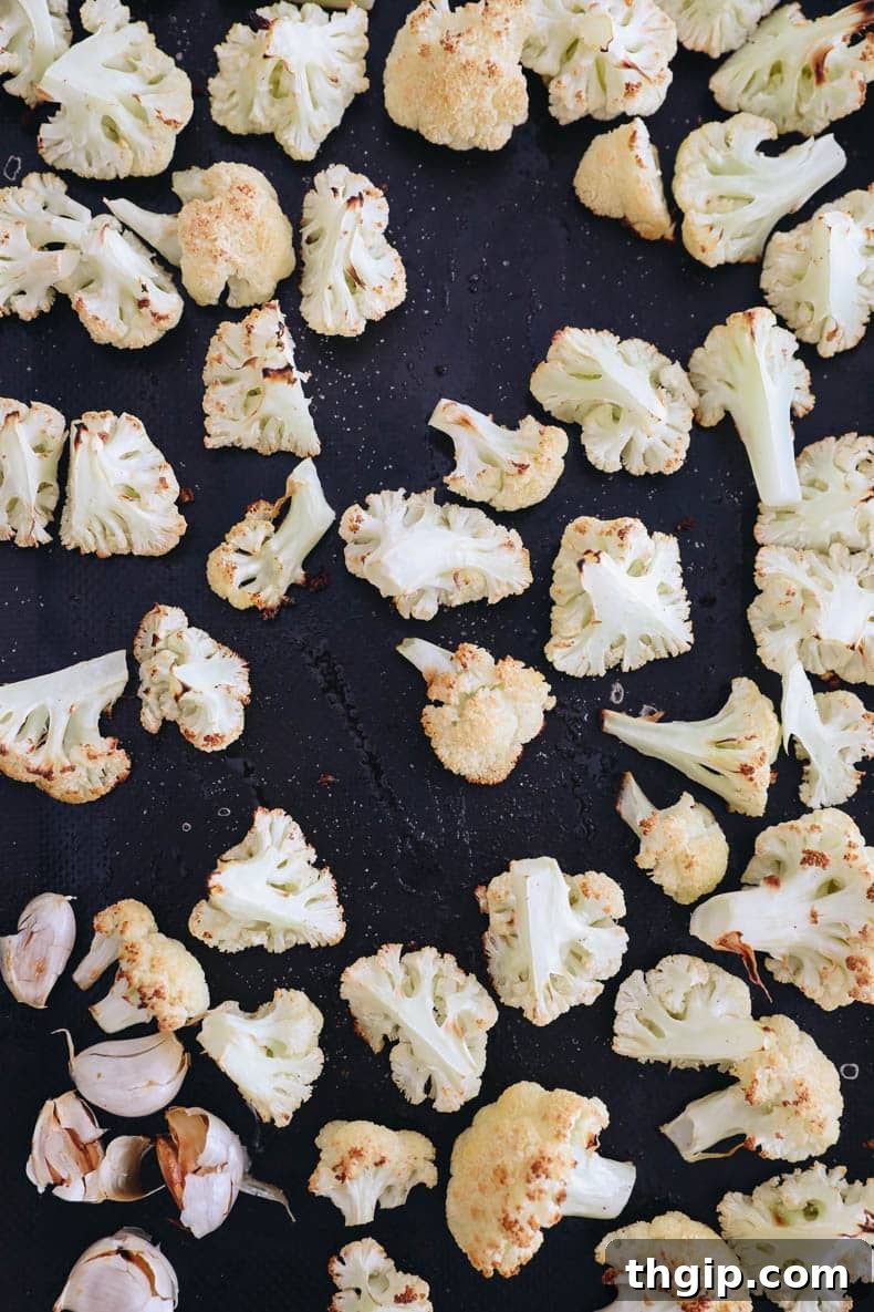 Golden Roasted Cauliflower Soup 3 roasted cauliflower and garlic on a sheet pan.