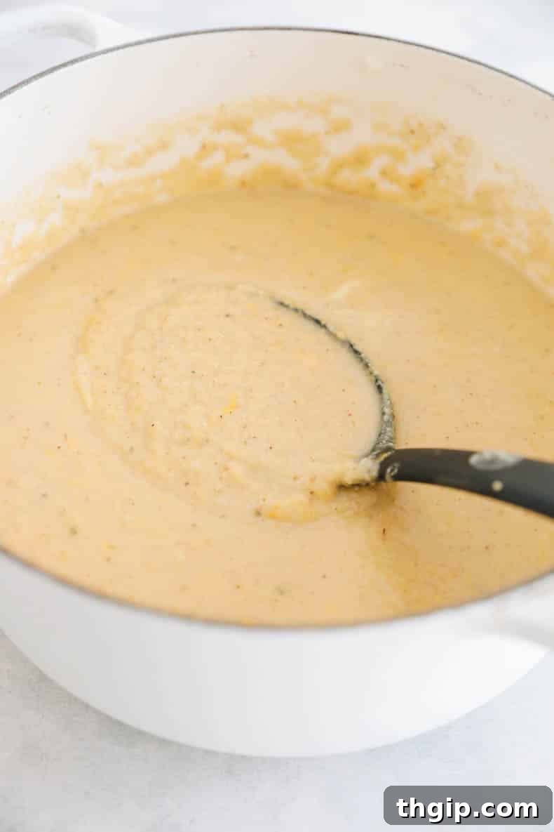 Golden Roasted Cauliflower Soup 6 pot of roasted cauliflower soup with a ladle.