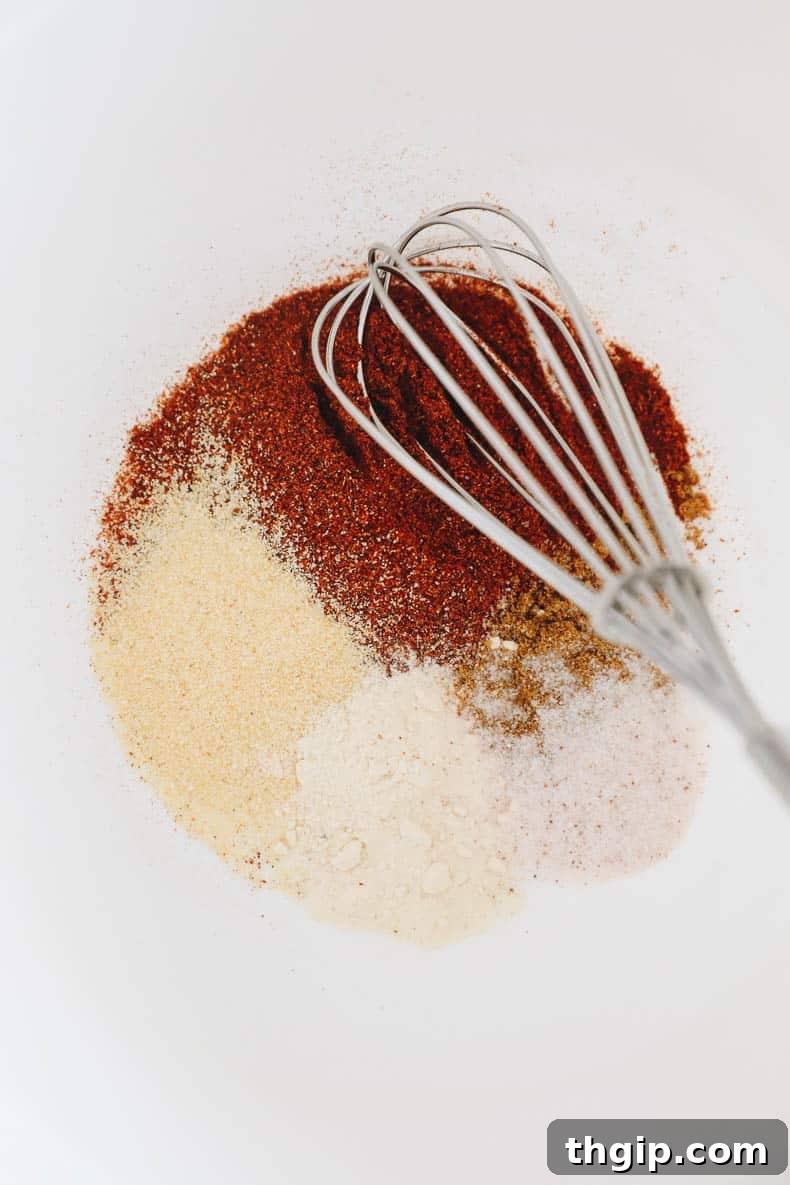 Effortless Fajita Feast 3 Fajita seasoning mixed in a large bowl, ready for the chicken and vegetables.