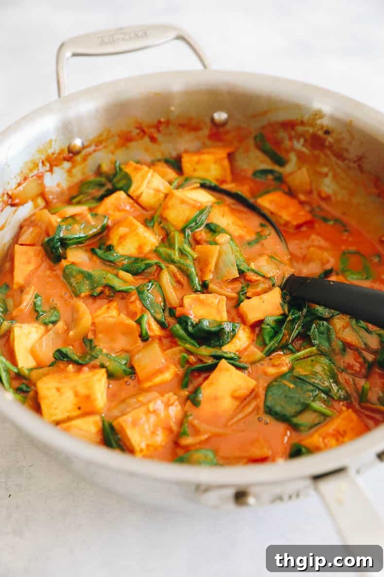 Golden Coconut Tofu Curry 5 Yellow tofu curry cooked in a pot, ready to be served.