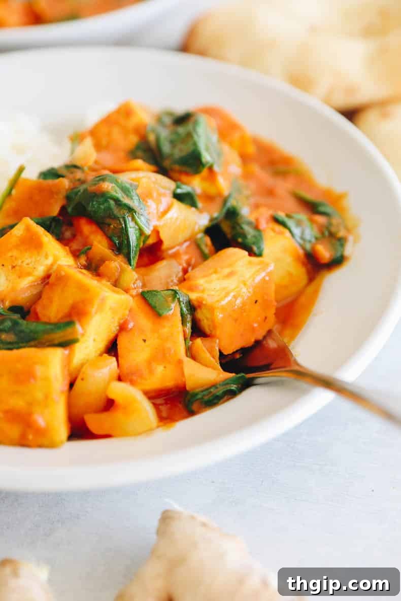 Golden Coconut Tofu Curry 6 Overhead shot of a bowl of Tofu Curry with rice, showing its vibrant color and textures.