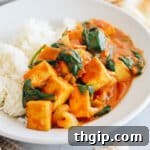 tofu curry in a white bowl with rice.