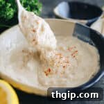 A close-up view of the smooth and creamy tahini sauce in a minimalist bowl, showcasing its rich texture.