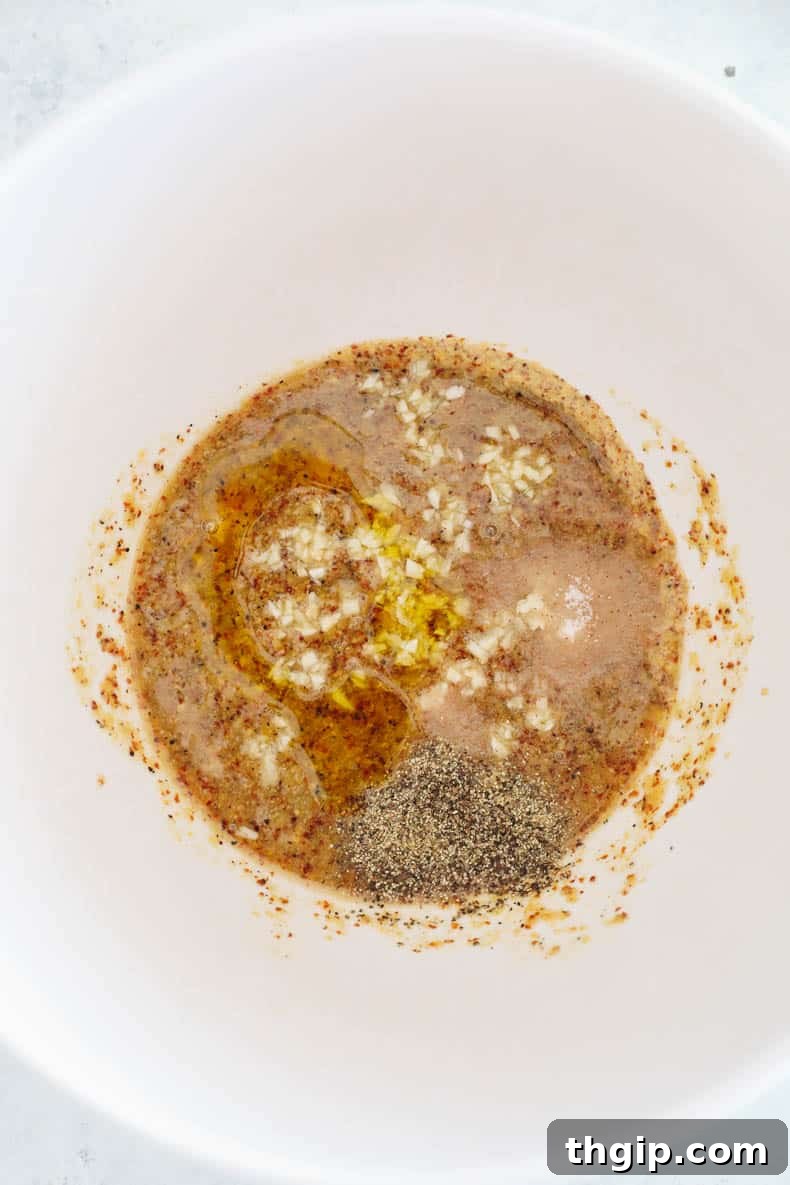 Preparing the honey mustard chicken marinade in a bowl.