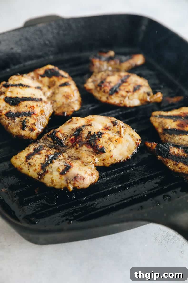 Perfectly grilled honey mustard chicken on a cast iron grill pan, ready to be served.