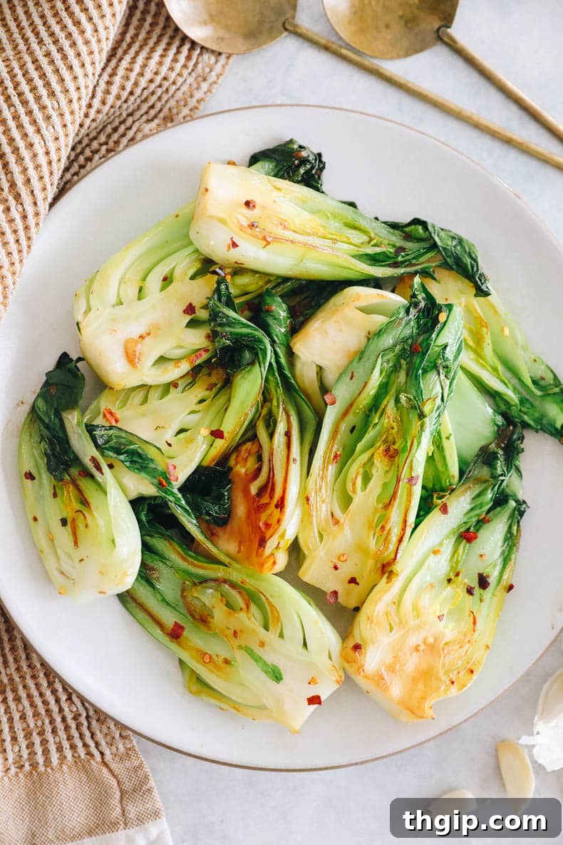 Garlicky Baby Bok Choy Sauté 2 Garlic baby bok choy recipe stacked on a plate, ready to be served.
