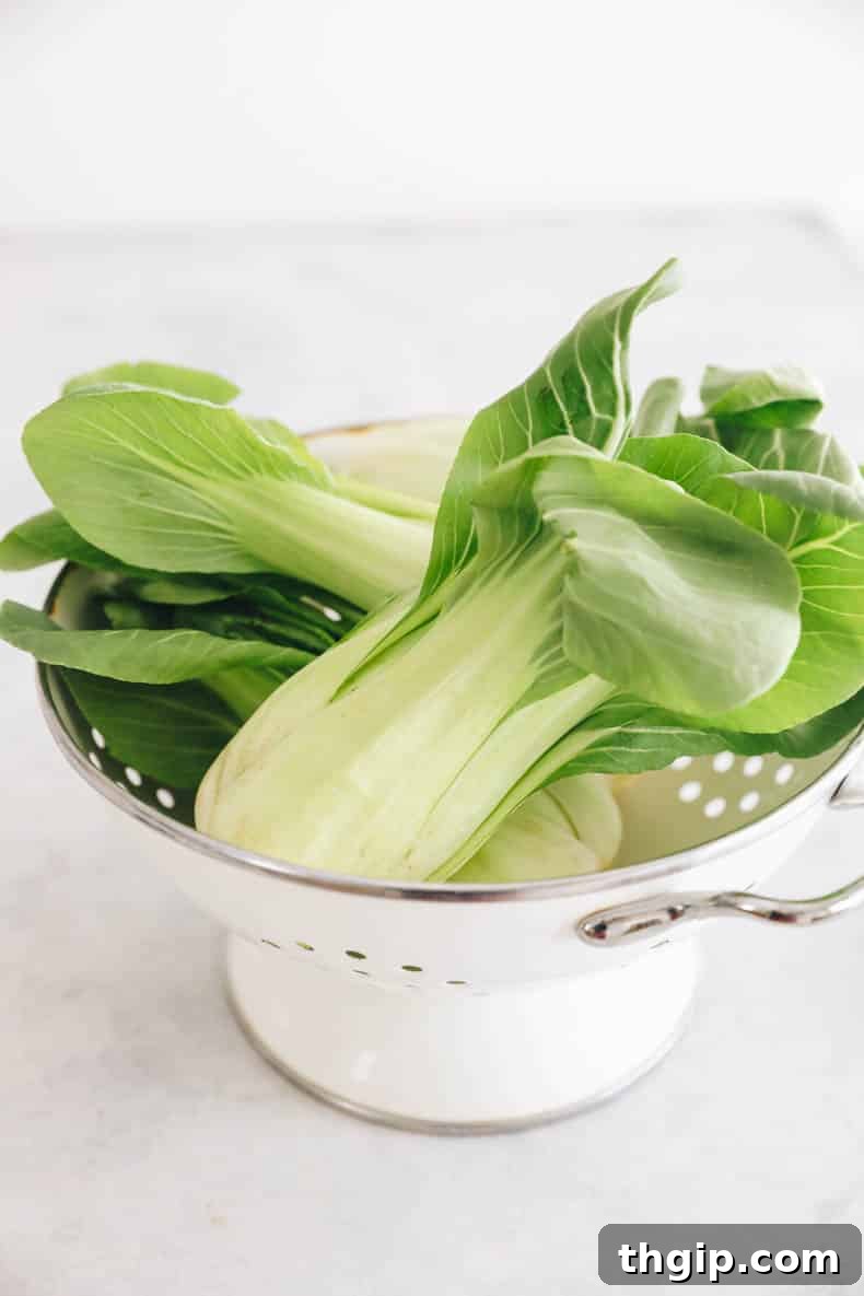 Garlicky Baby Bok Choy Sauté 3 Baby bok choy in a colander, freshly rinsed and ready for cooking.