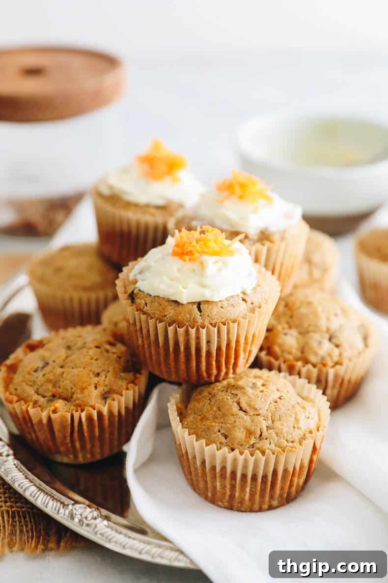 Carrot Cake Bites 2 Freshly baked carrot cake muffins on a cooling rack.