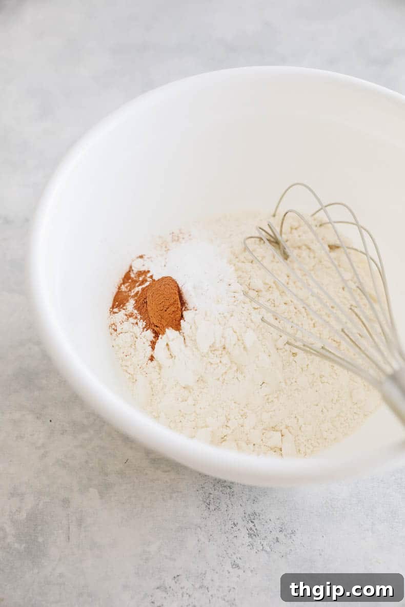 Carrot Cake Bites 3 Dry ingredients for carrot cake muffins in a mixing bowl.