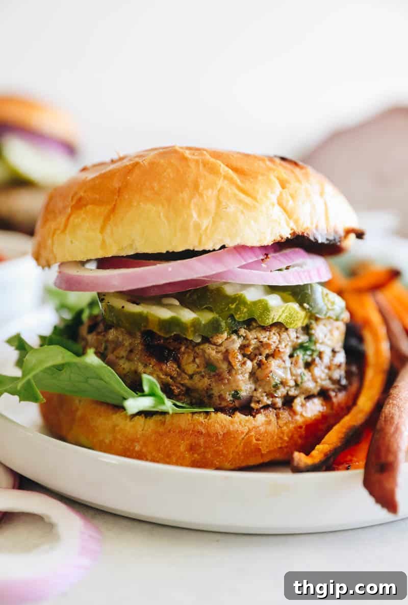 Perfect Turkey Burgers Every Time 2 turkey burger on a bun with pickles and onion