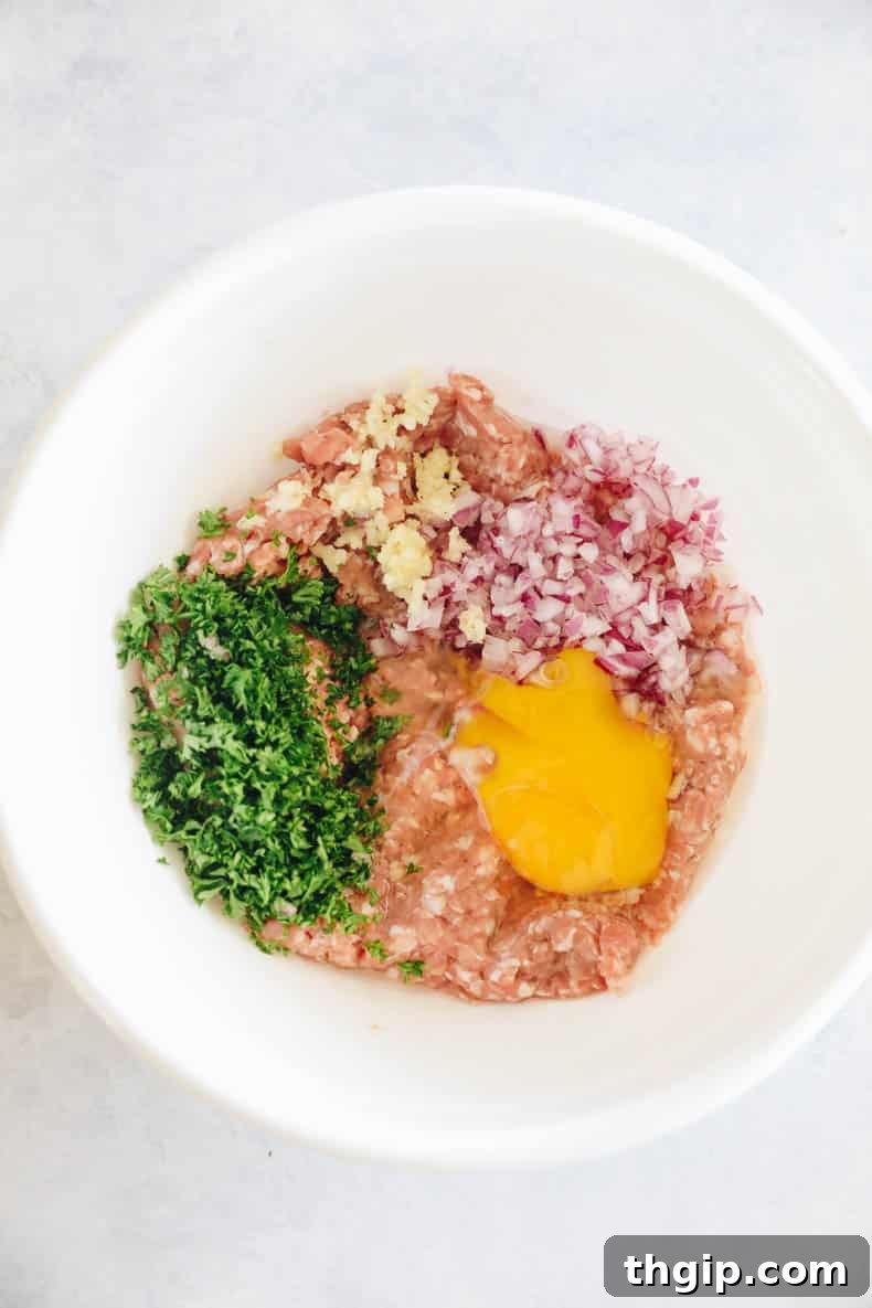 Perfect Turkey Burgers Every Time 3 ingredients in a large white bowl.