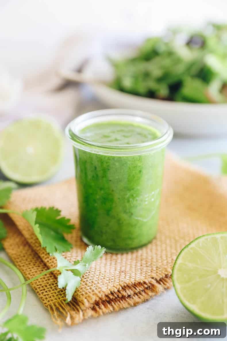 Vibrant Cilantro Lime Dressing 2 Freshly blended cilantro lime dressing in a mason jar, ready to be served.