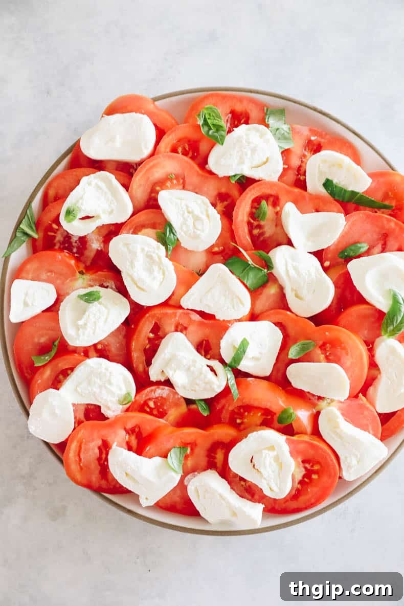 A visual step-by-step of preparing burrata salad, showing sliced tomatoes and burrata cheese arranged on a platter.
