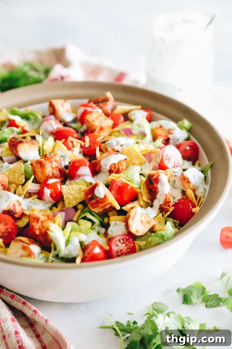overhead image of BBQ chicken salad in a large serving bowl with greek yogurt ranch dressing.