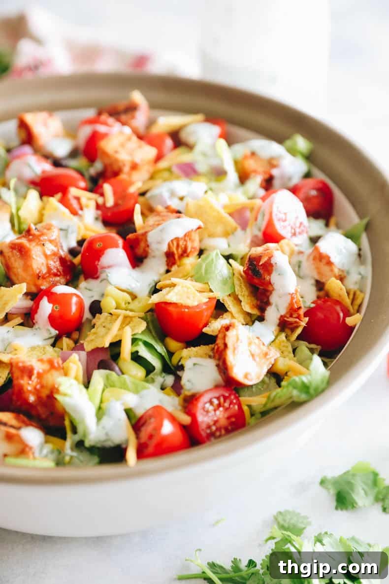 BBQ chicken salad in a large salad bowl with ranch dressing.