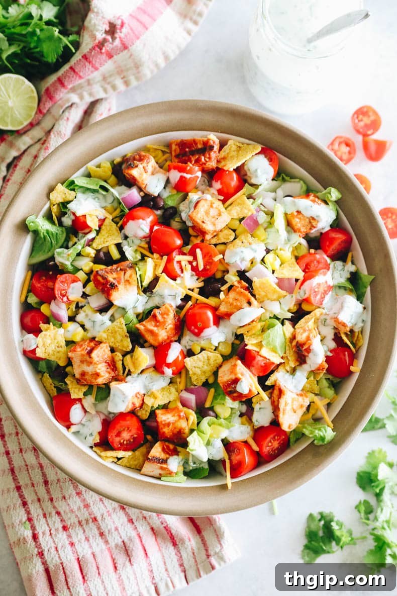 overhead image of BBQ chicken salad in a large serving bowl with greek yogurt ranch dressing.