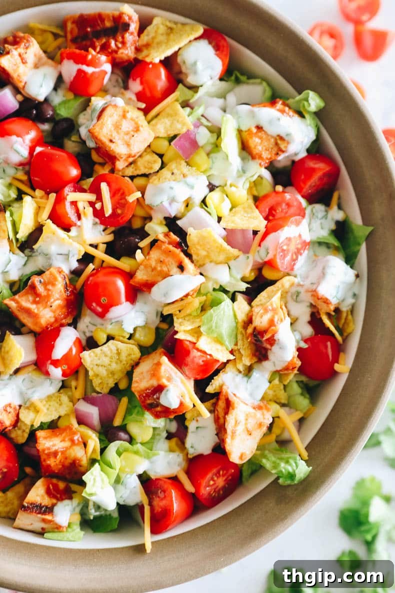 overhead image of BBQ chicken salad in a large serving bowl with greek yogurt ranch dressing.