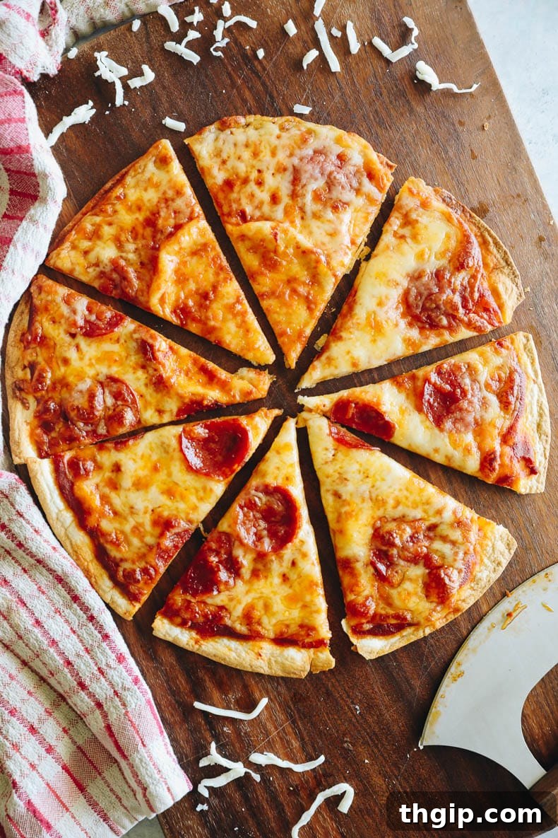 Crispy Tortilla Pizza 2 Crispy tortilla pizza with pepperoni on a cutting board, ready to be served.