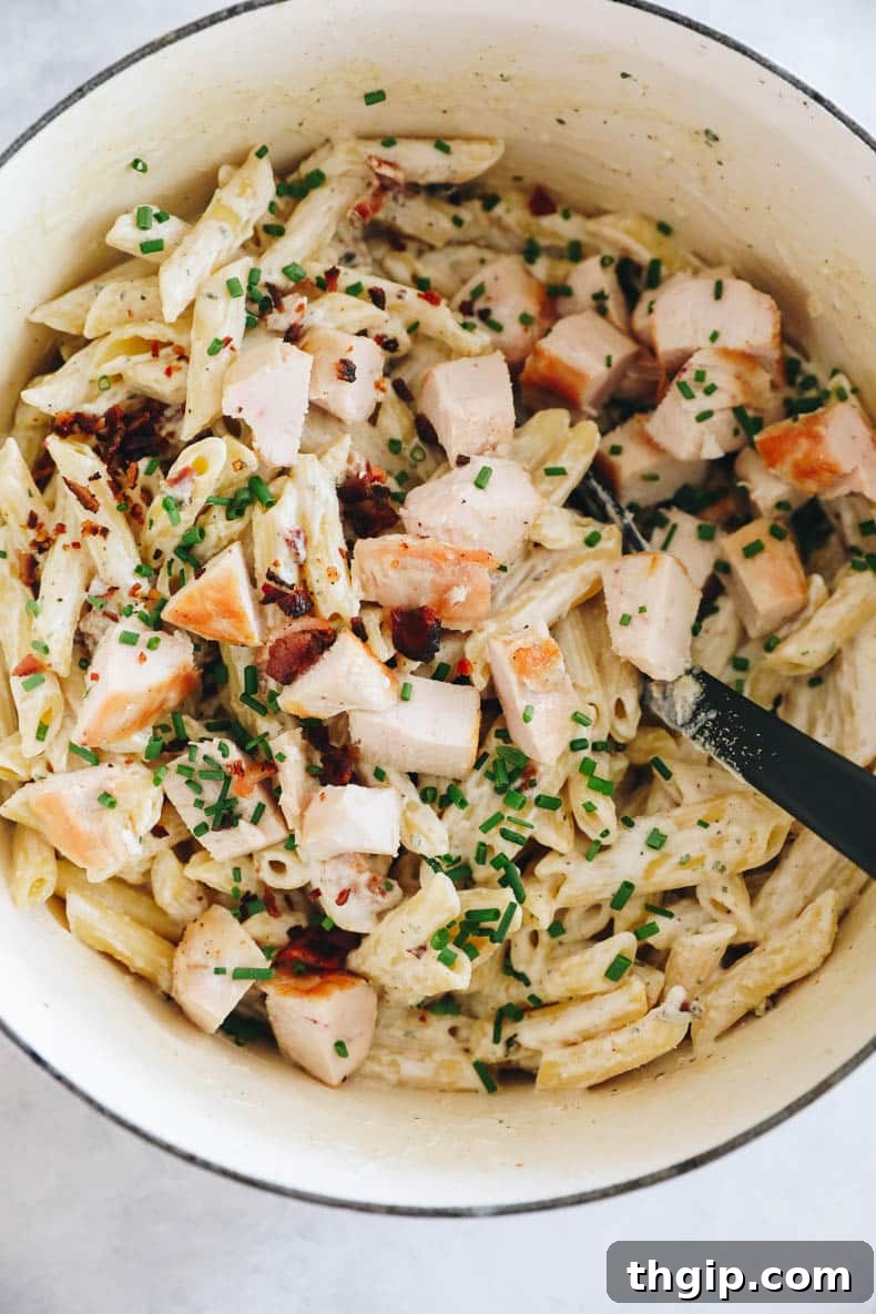 The finished chicken bacon ranch pasta, rich and creamy, stirred together in a large pot, ready to be served and enjoyed by everyone.